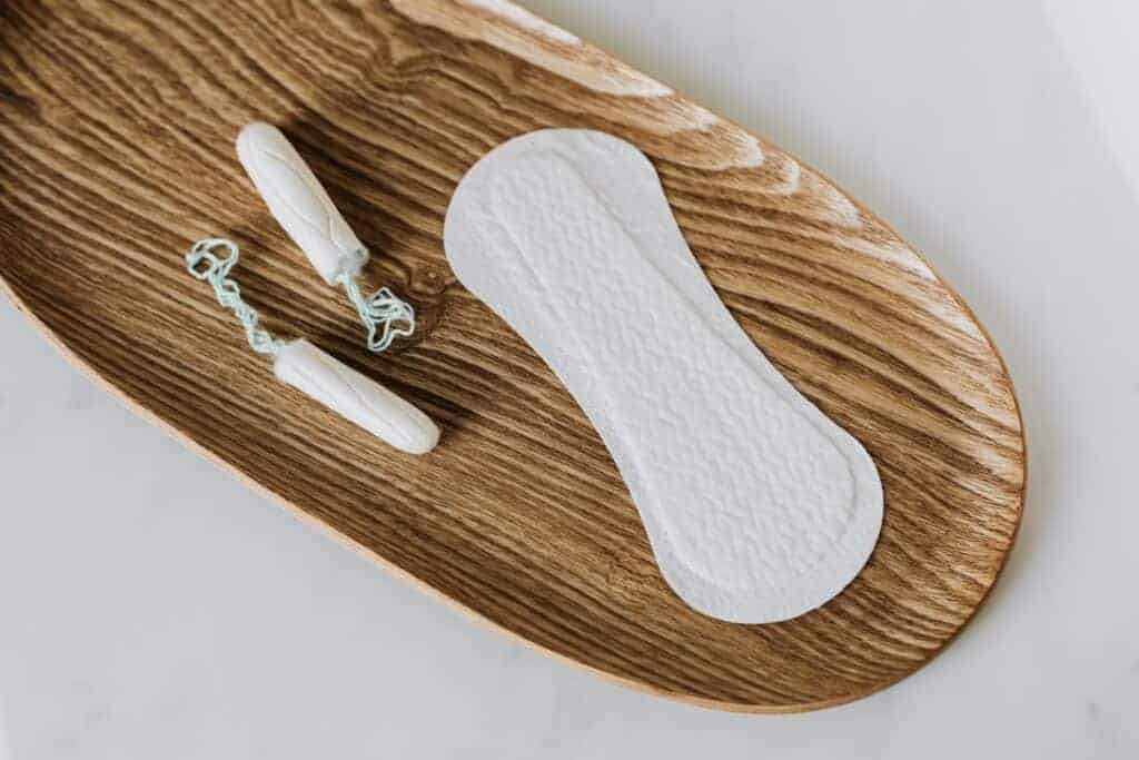 Tampon and pad on wooden board